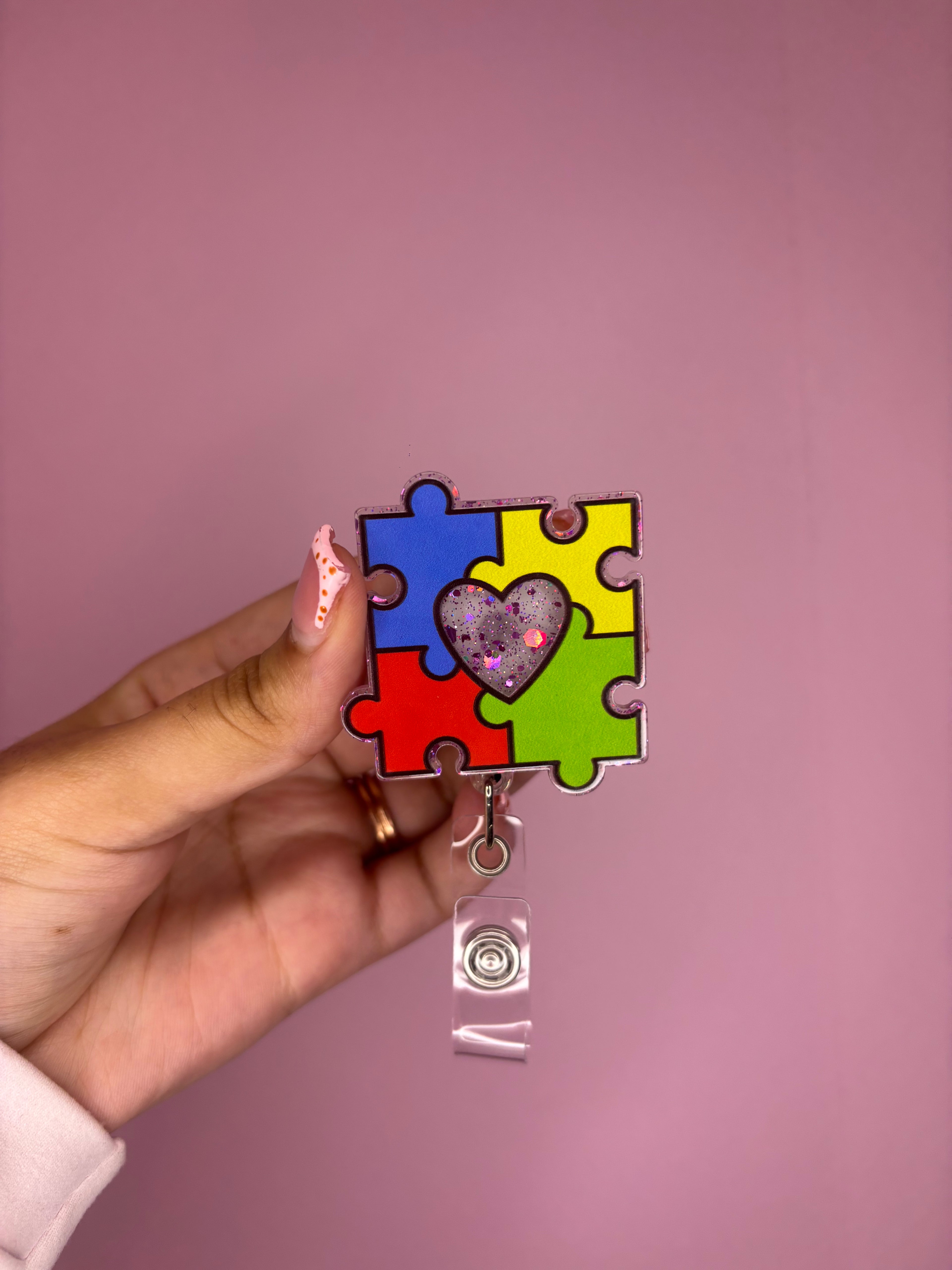 puzzle pieces badge reel